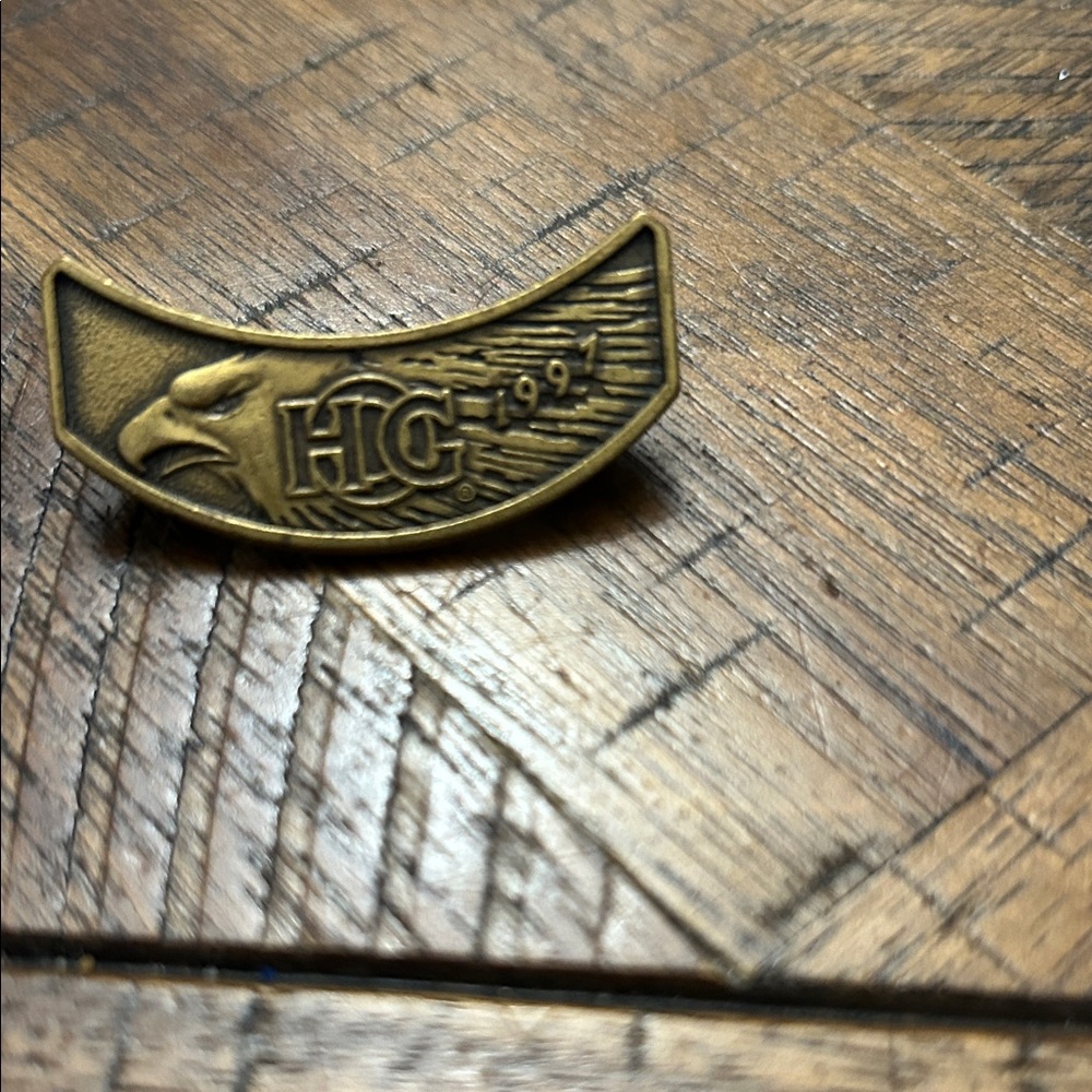 vintage brass lapel pin featuring a bald eagle logo and the year 1997.